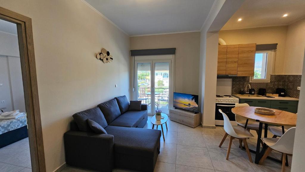 a living room with a couch and a table and a kitchen at Estia Chios Apartments B6 in Chios