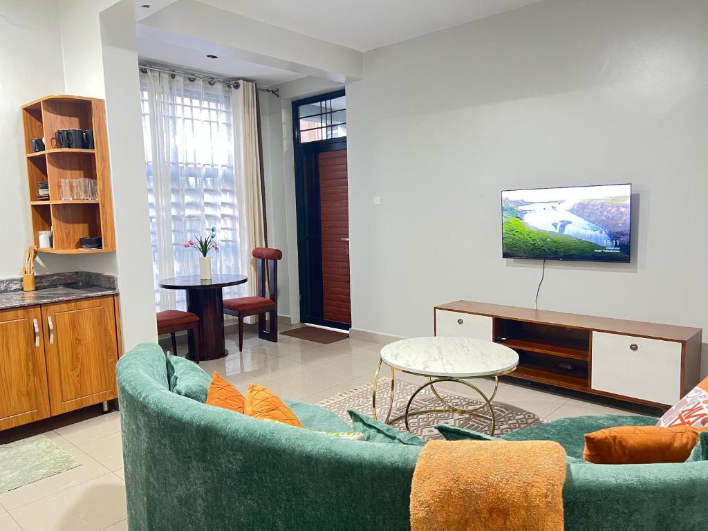 a living room with a couch and a table at Luxury Ntinda Apartment with Wi Fi and Netflix in Kampala