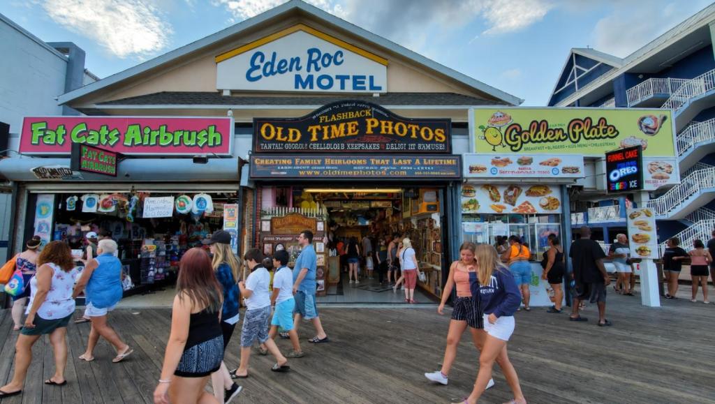 a group of people walking in front of a market at Eden Roc Downtown in Ocean City
