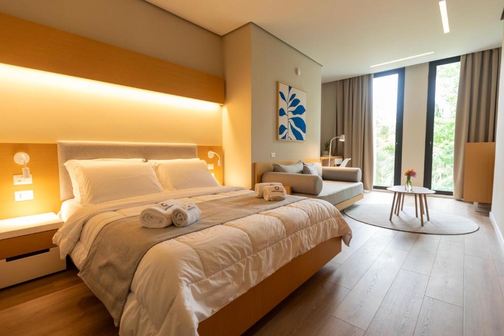 a bedroom with a large bed with towels on it at Hotel Bologna in Vlorë