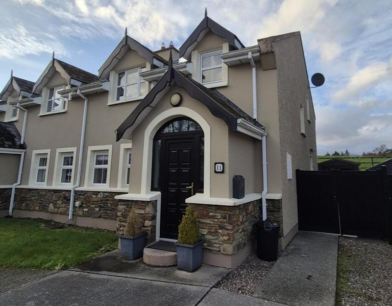 a house with a cross on the front of it at Central House Kenmare in Kenmare