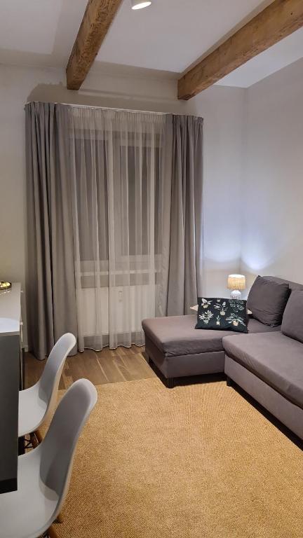 a living room with a couch and a table and chairs at Lovely 1-bedroom condo in Riga