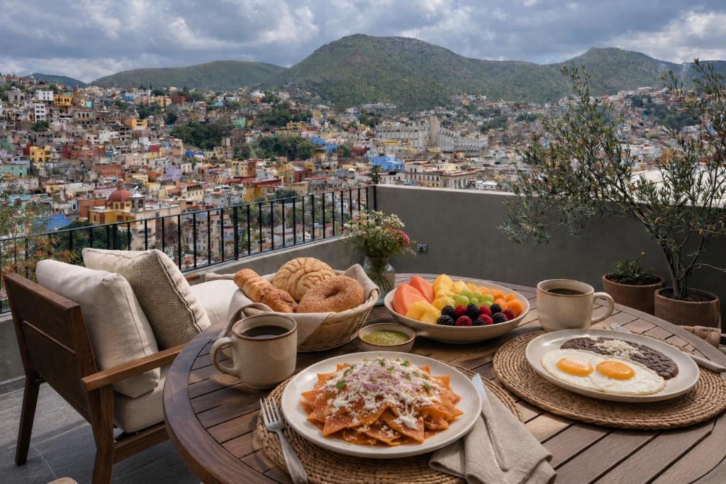 a table with plates of food on a balcony at Casas Balcón Gto in Guanajuato
