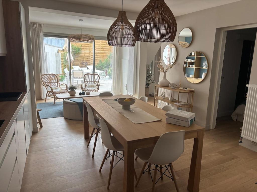 a kitchen and dining room with a table and chairs at La Dune Dorée Escapade Croteloise in Le Crotoy