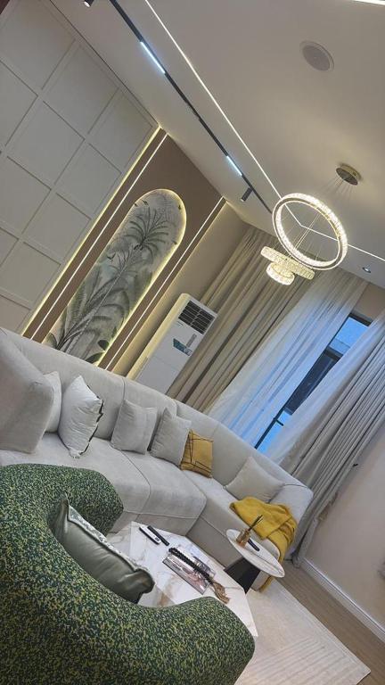 a living room with a couch and a chair at Vluxuries in Lekki