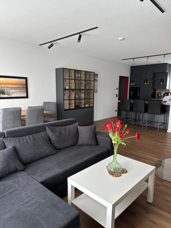 a living room with a couch and a table at Samtenssonne in Samtens