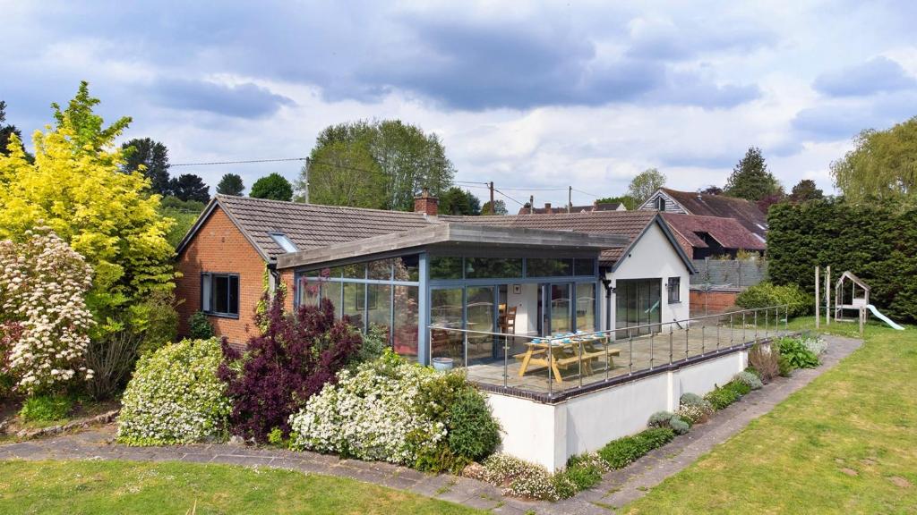 a home with a large glass house with a deck at Finest Retreats - Yonder Castle Hill in Harley