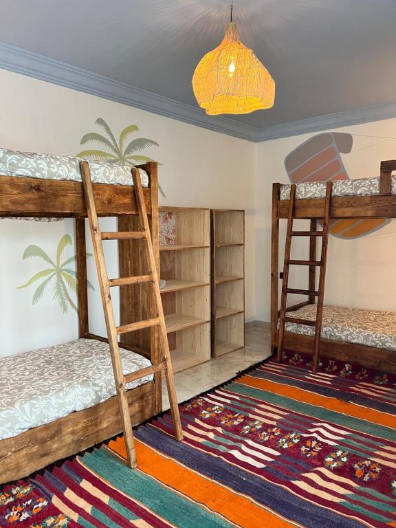 two bunk beds in a room with a rug at windora essaouira in Essaouira