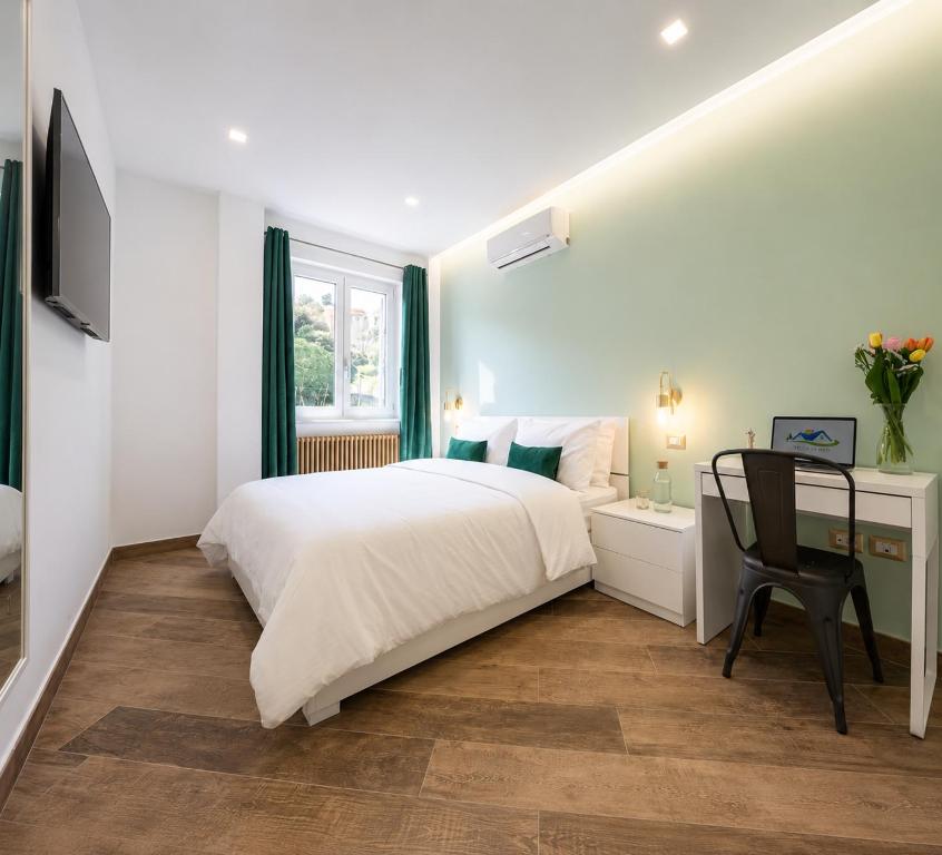 a white bedroom with a bed and a desk at Villa In Bed in Naples