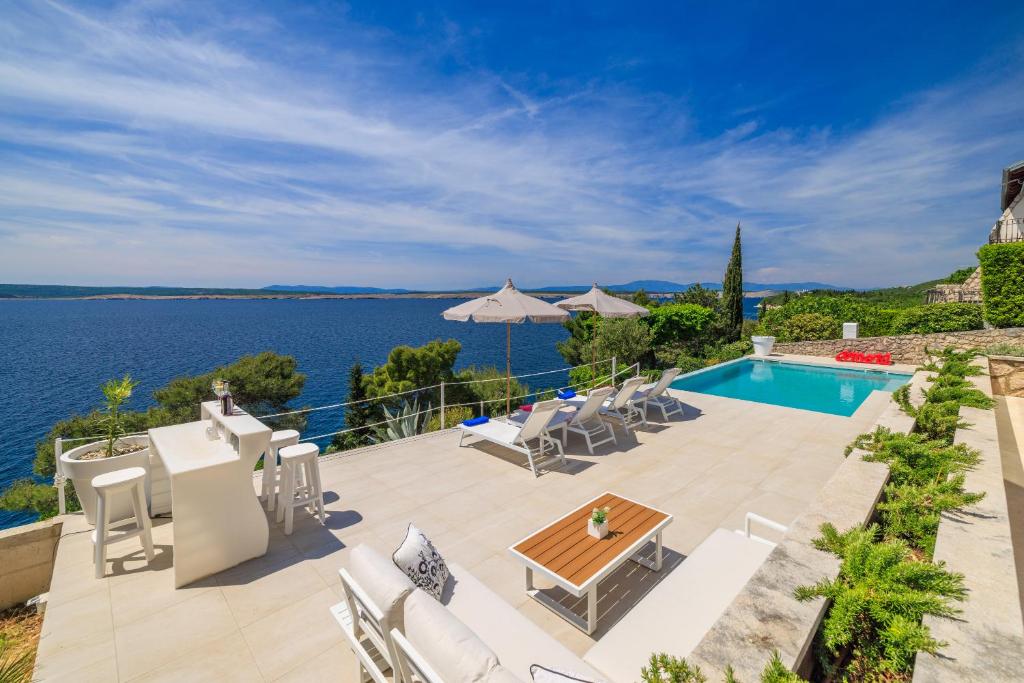 a villa with a swimming pool and a patio at Villa Empress in Dramalj