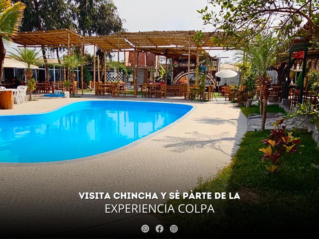 a swimming pool at a resort with a restaurant at Hacienda Hotel Colpa in Chincha