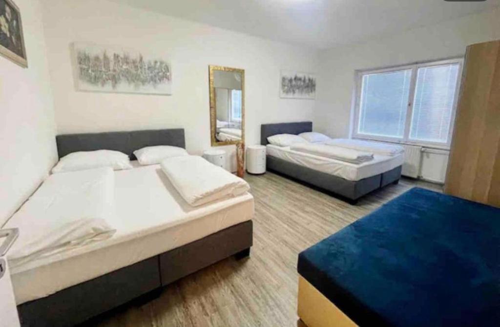 a bedroom with two beds and a mirror at Mozart Salzburg Residence in Salzburg