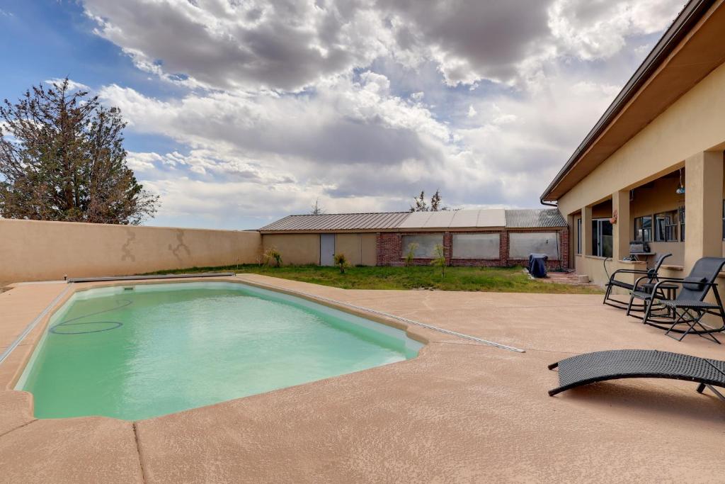 a swimming pool in the backyard of a house at Golf, Lakes & Trails! Truth Or Consequences Home in Truth or Consequences
