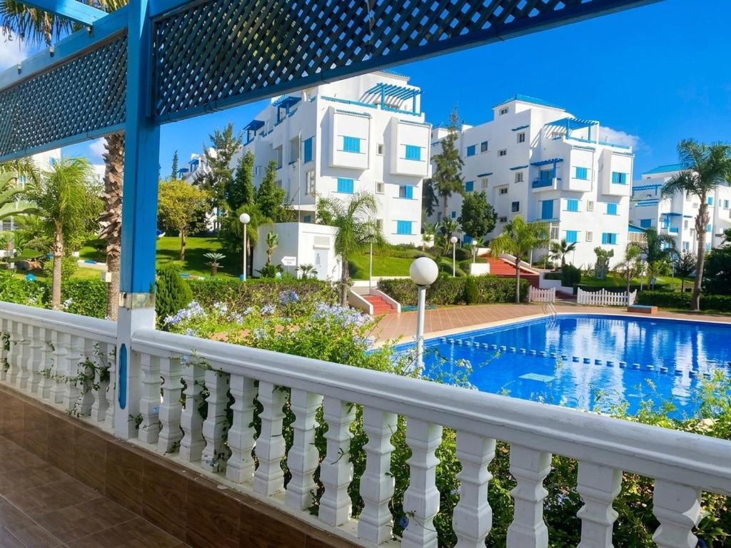 a balcony with a swimming pool and buildings at Luxury apartment Smir Park - Marina Smir in Marina Smir