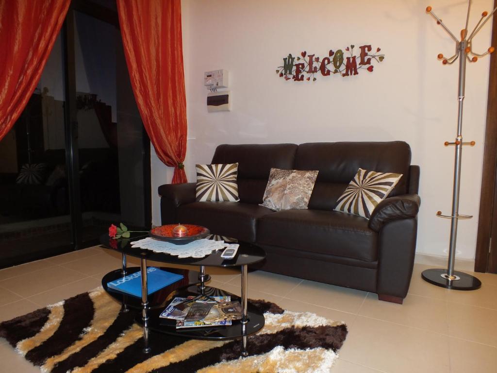 a living room with a couch and a table at Marjanapartment in Marsaskala