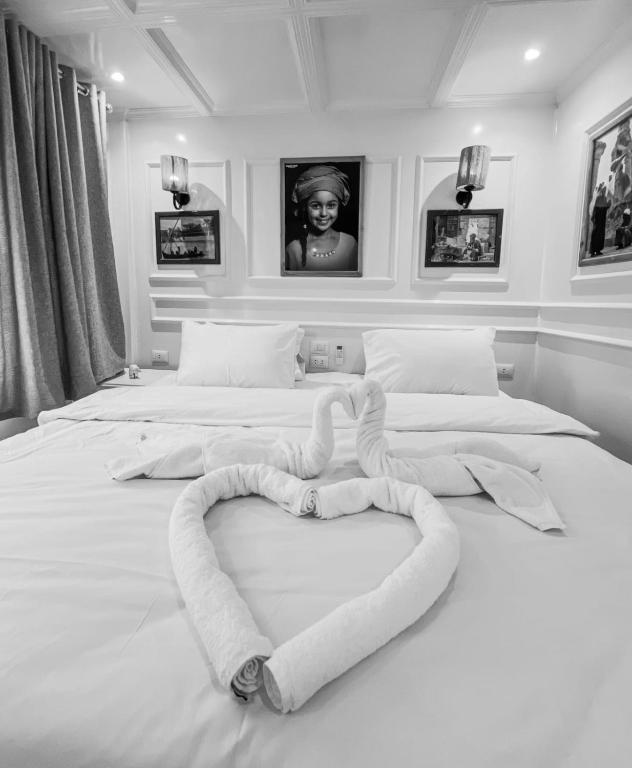 a bed with a heart made out of towels at Youssef Nile Boat in Luxor