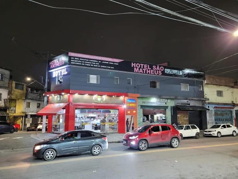 a group of cars parked in front of a building at Hotel São Mateus in São Paulo