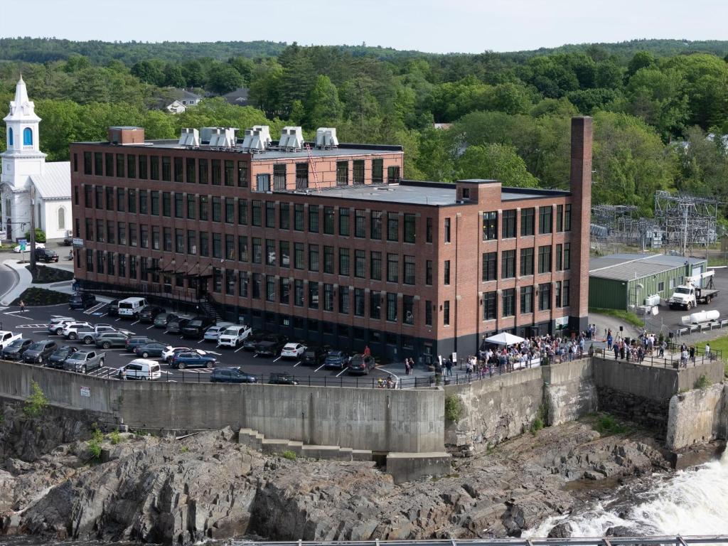 a building with a lot of people standing outside of it at The Skowhegan By Kasa in Skowhegan