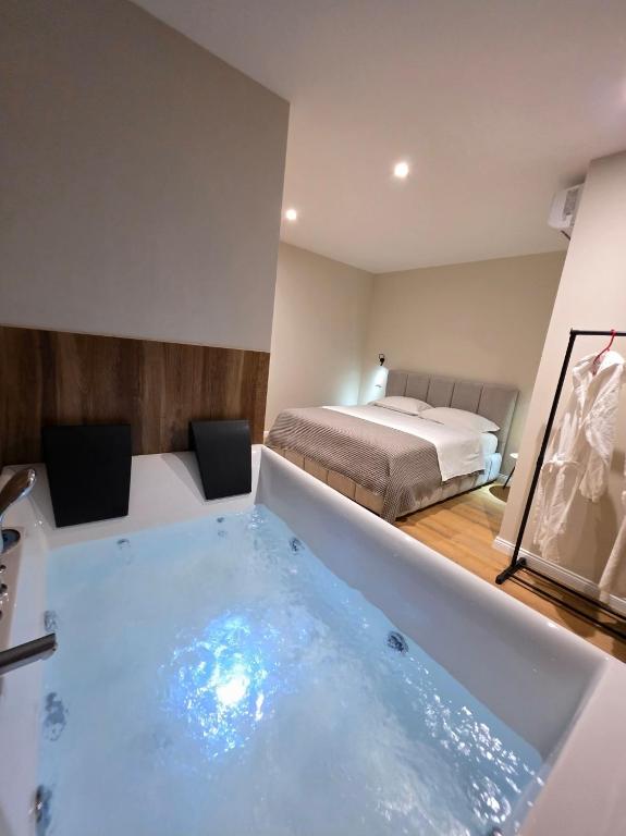 a room with a bath tub with a bed at JACUZZI LIVING TIRANA center 1 in Tirana
