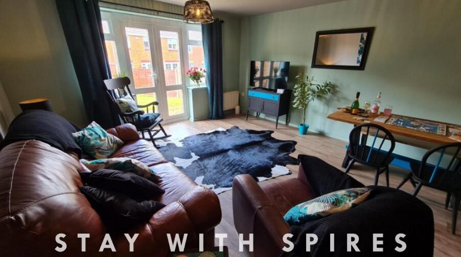 a living room with a couch with a smashed up rug at The Farrier's recently refurbished 3 bedroom comfy and cosy bolt hole close to Cannock town centre in Hednesford