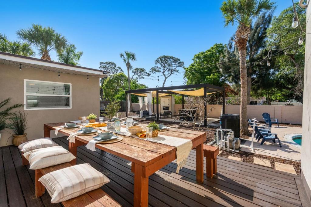 a patio with a wooden table and chairs on a deck at 1055 Shady Lane in Merritt Island