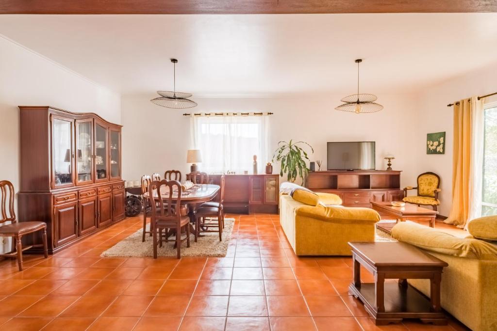 a living room with a couch and a table at Ben House, private parking in Ponta Delgada