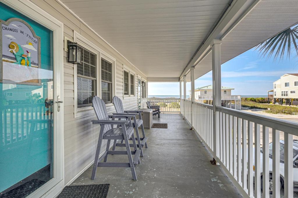 a porch with chairs and a view of the ocean at Steps to Beach! North Myrtle Beach (Cherry Grove) in Myrtle Beach