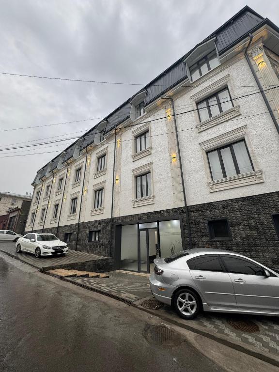 a silver car parked in front of a building at Samanid hotel in Salor Bekati