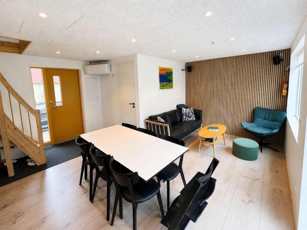 a living room with a table and chairs and a couch at Hvanngarðs Smáttan by Stóra in Dalur
