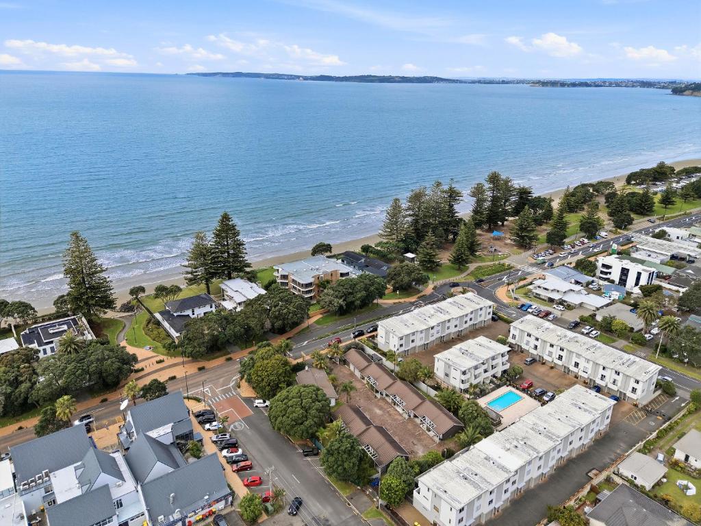 an aerial view of a town next to the ocean at Orewa Motor Lodge in Orewa