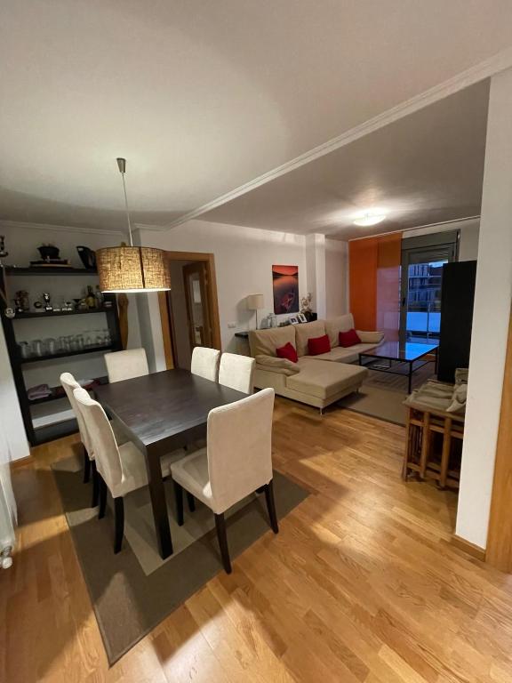 a dining room and living room with a table and chairs at Apartamento Robledal de Cirueña in Cirueña