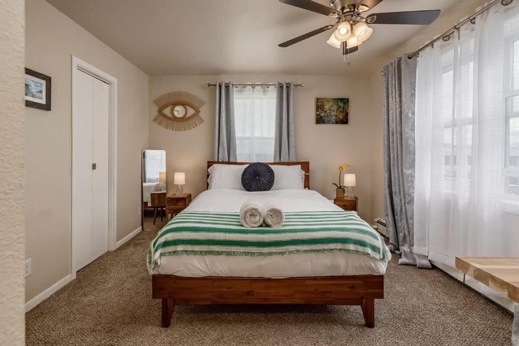 a bedroom with a bed with two slippers on it at Historic Downtown Deco Queen Studio in Anchorage