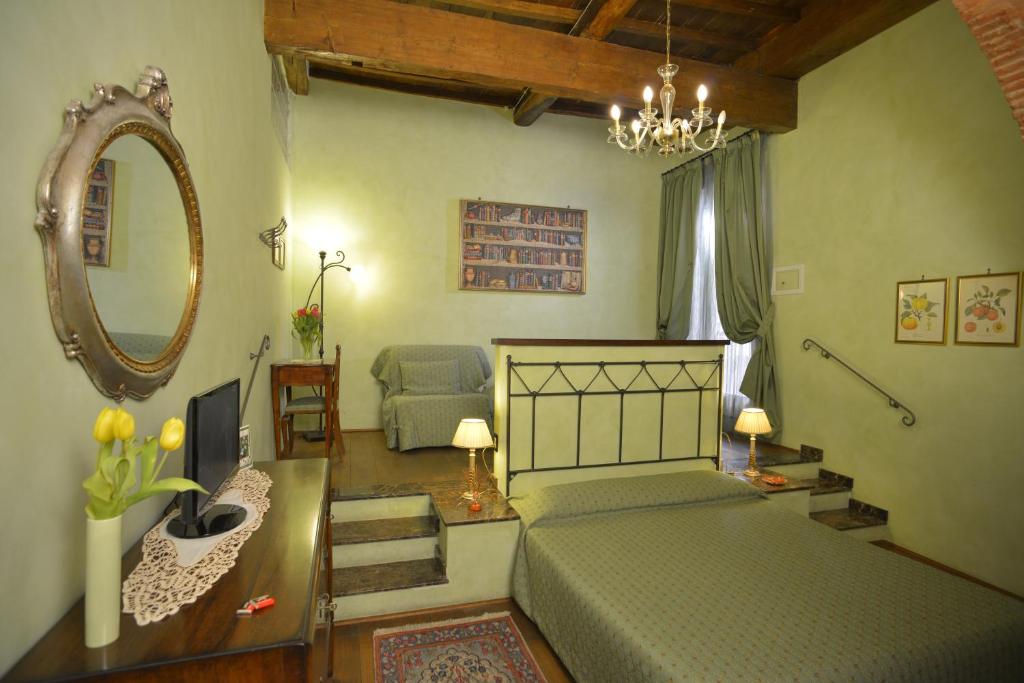 a bedroom with two beds and a mirror at B&B La Casa dei Tintori in Florence