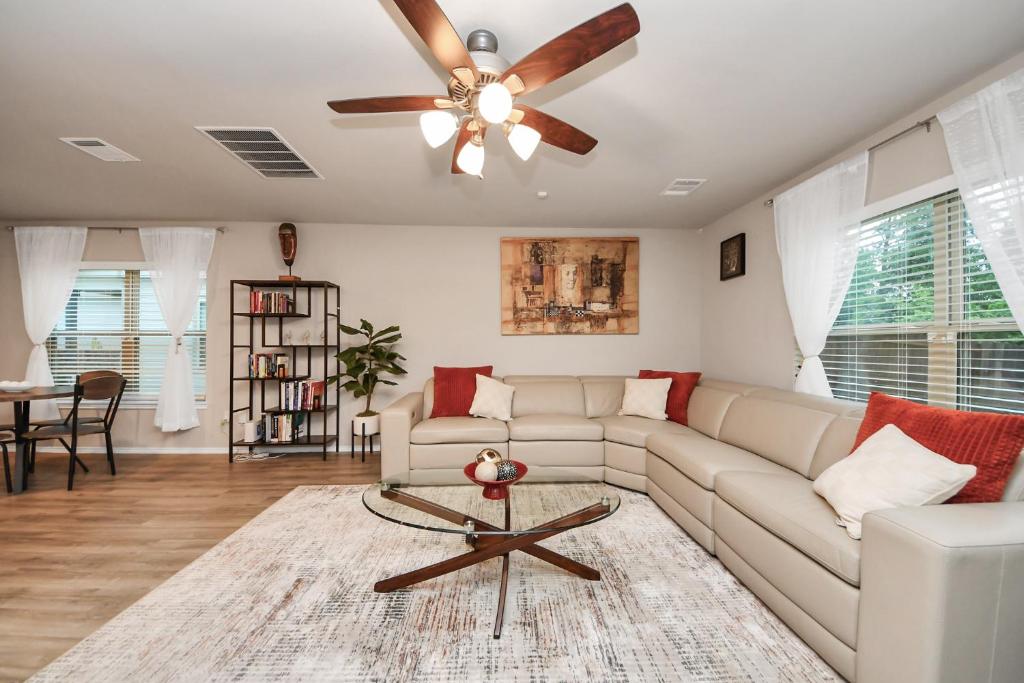 a living room with a couch and a ceiling fan at Modern Living, Close to Everything in Houston