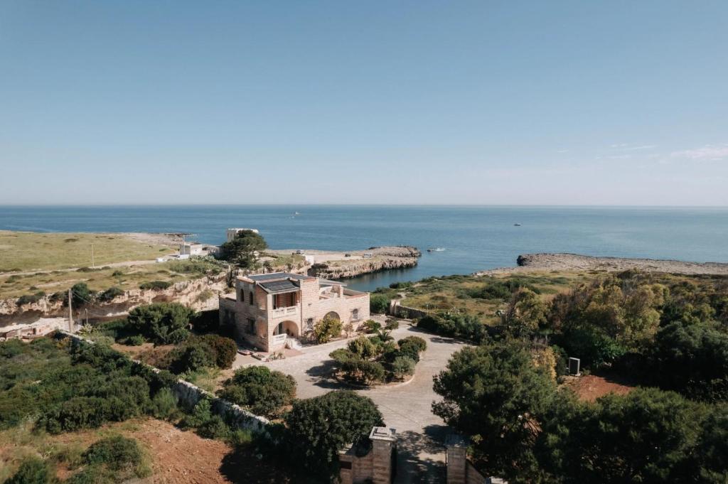 a house on a hill next to the ocean at Villa Incina - Sea House in Polignano a Mare
