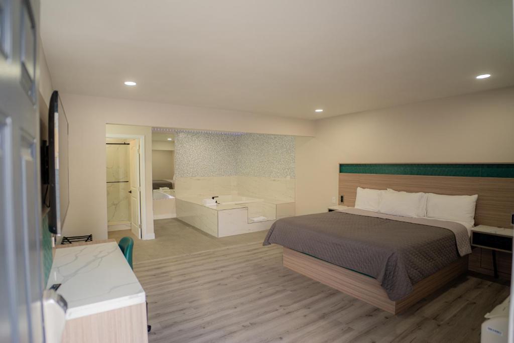 a bedroom with a bed and a bath room at Flamingo Motel near Universal Studios in North Hollywood