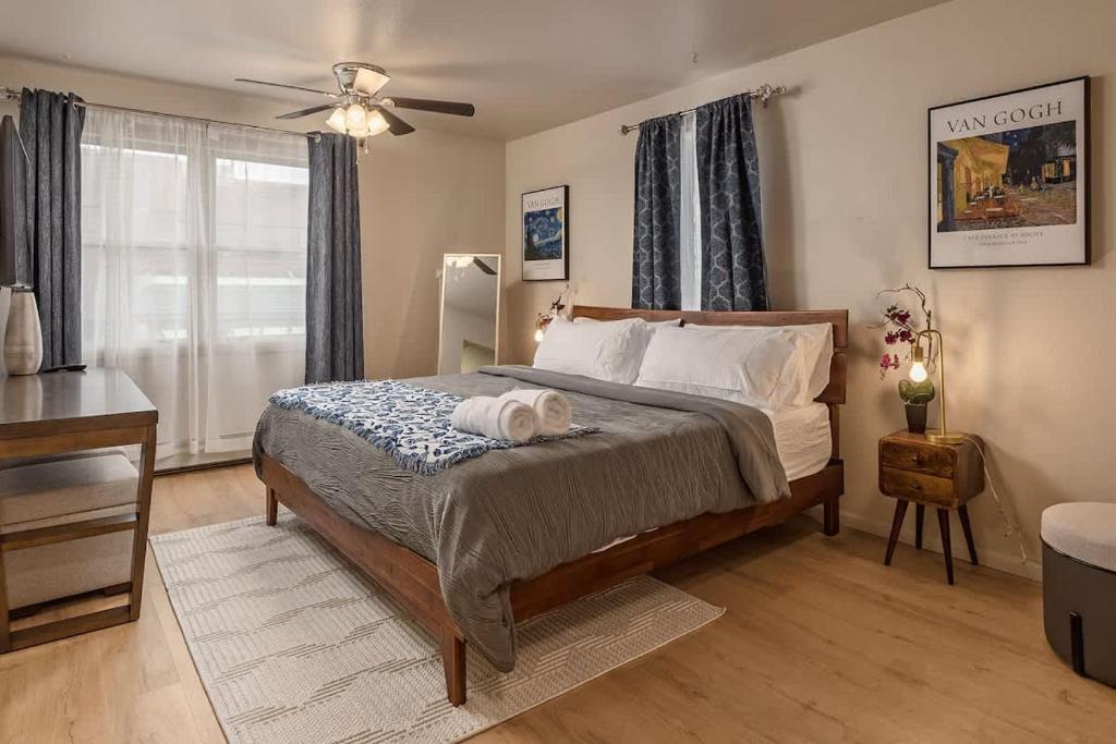a bedroom with a bed and a ceiling fan at Spacious King Historic Art Deco Studio in Anchorage