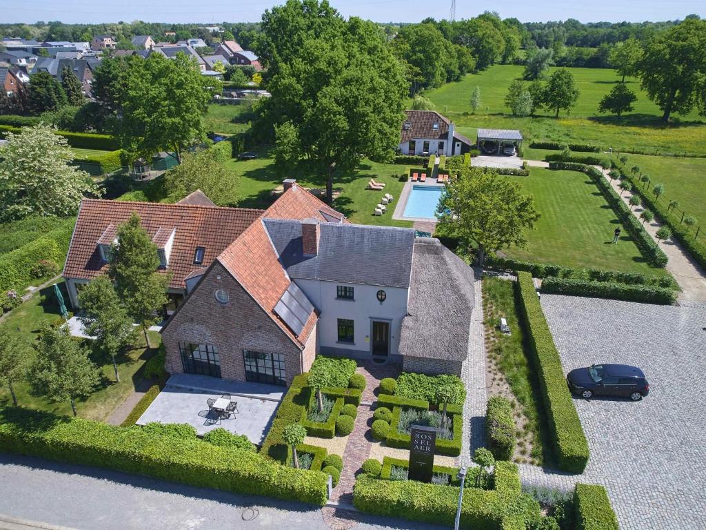 an aerial view of a large house with a yard at Rosselaer in Balen