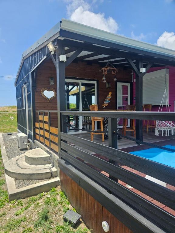 a house with a deck and a swimming pool at Bungalow Sugarcane in Saint-Louis