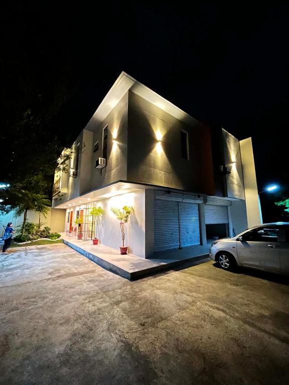 a car parked in front of a house at night at Residencia de Azucena in Tacloban