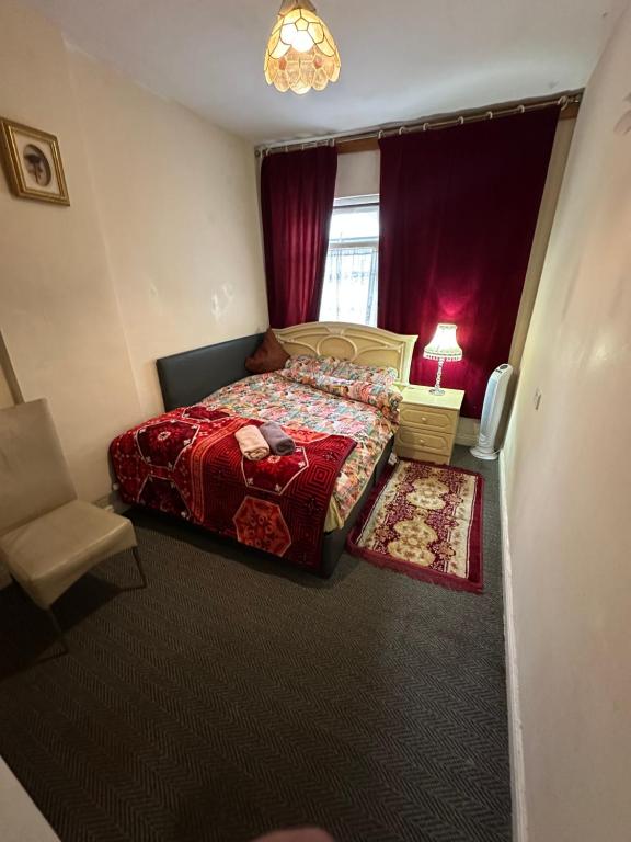 a bedroom with a bed and a chair and a window at Quiet Nest 2 in Coventry