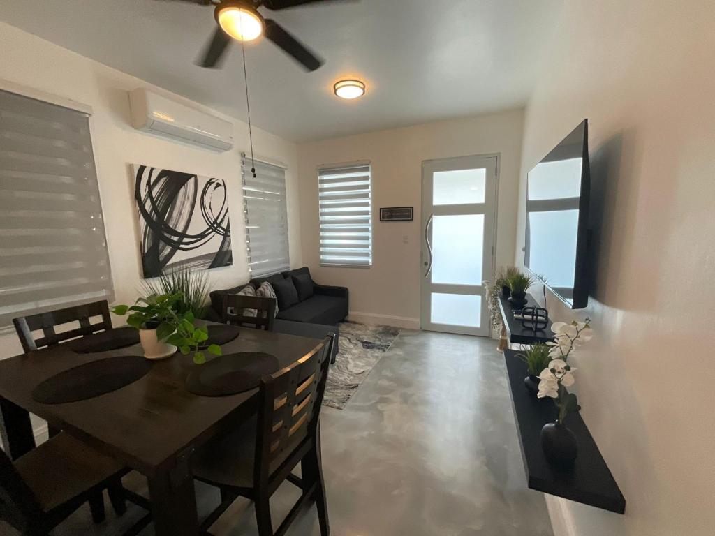 a dining room and living room with a table and chairs at El Amanecer del Este 3 in Fajardo