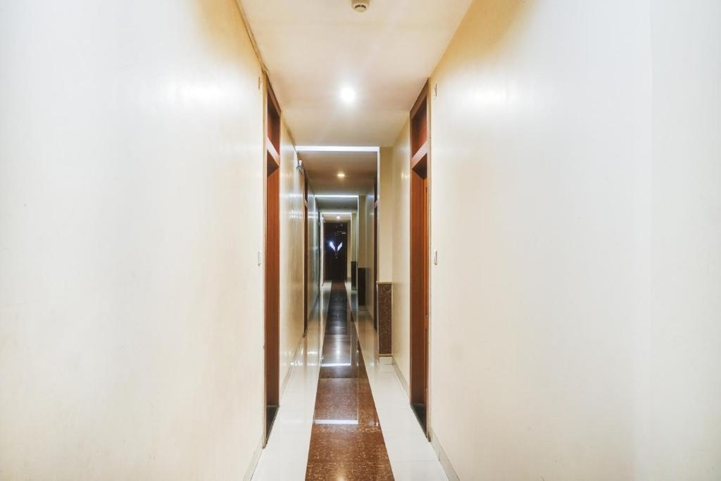 a corridor in a hotel room with a long hallway at Hotel O Span Executive in Pune