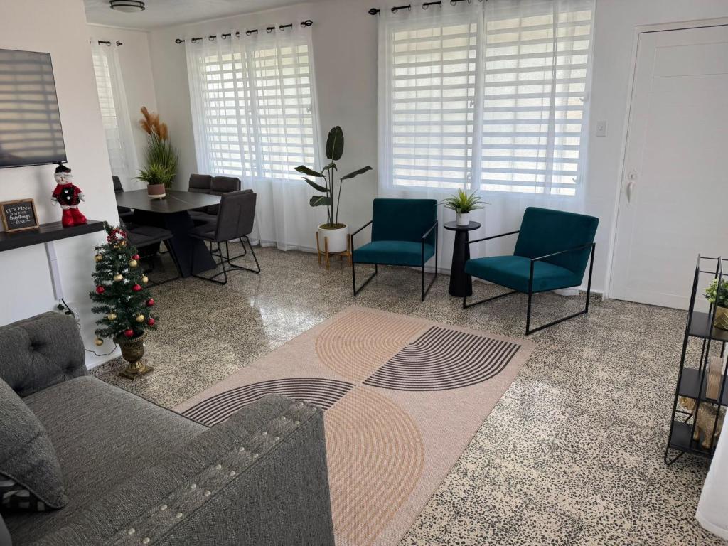 a living room with a couch and chairs and a christmas tree at El AMANECER DEL ESTE in Fajardo