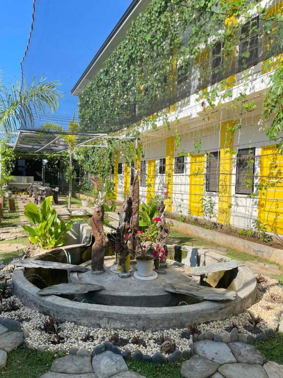 a courtyard with a fountain in front of a building at BC Lodge in Puerto Princesa City