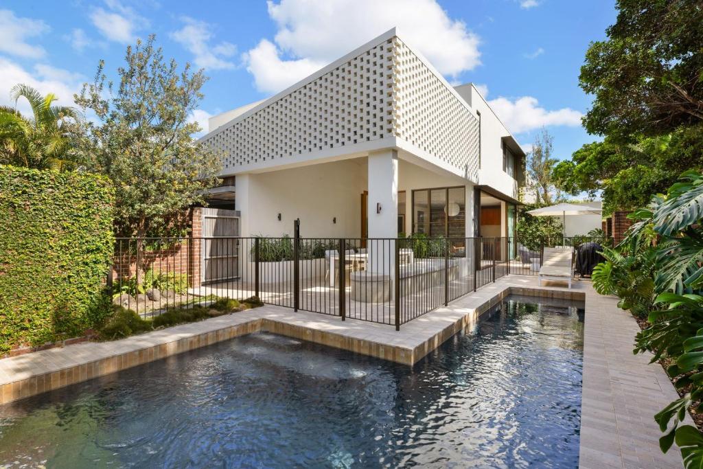a house with a swimming pool in front of a house at Villa Alcorn in Suffolk Park