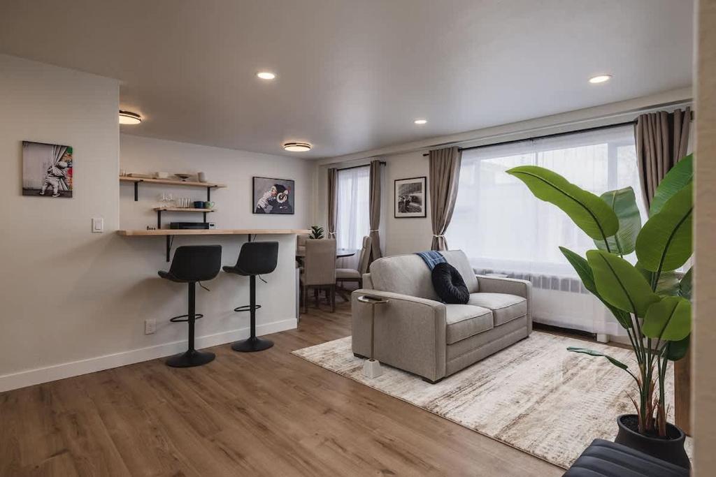 a living room with a couch and a table at Inlet View Luxe -King Suite - Downtown Anchorage in Anchorage