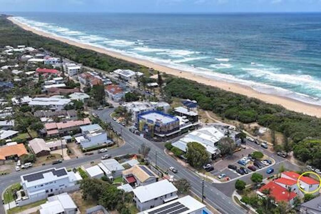an aerial view of a city and the beach at Beachfront 1BR Loft. Surf-Café-Unwind in Marcoola