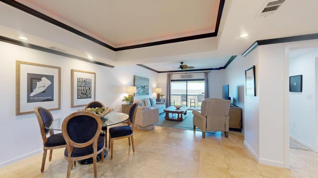 a dining room and living room with a table and chairs at 240 Captains Quarters in Hilton Head Island