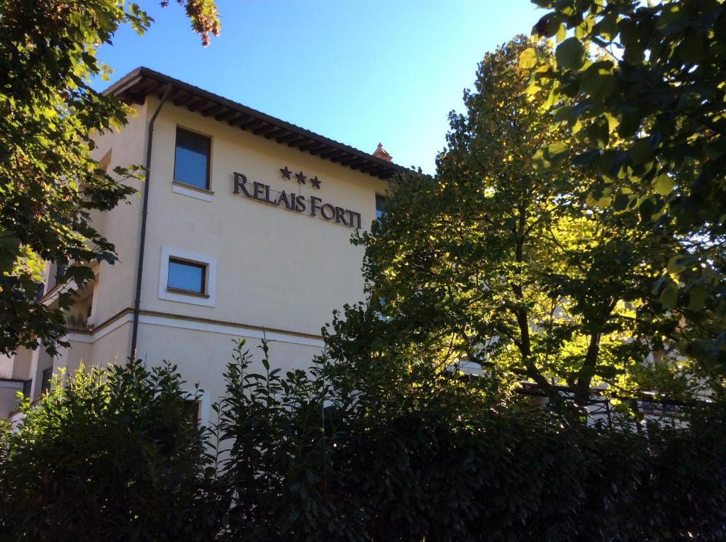 a white building with the words measles form on it at Relais Forti in Colfiorito